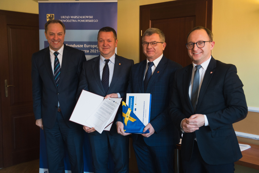 Cztery osoby prezentują podpisaną umowę, w tym marszałek Mieczysław Struk oraz wicemarszałek Marcin Skwierawski