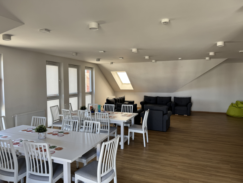 Przestrzeń wspólna budynku. Krzesła, sofy, okna.